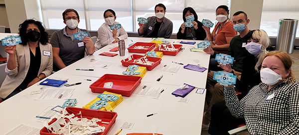 Nine Novartis associates show the first monoscopes that they assembled for Boston Public Schools' middle school students to learn Next Generation Science Standards on 9/15/22.